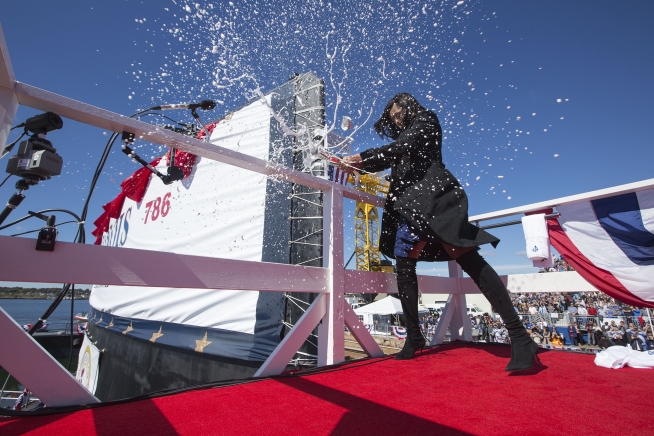 First Lady Michelle Obama breaks a bottle of champagne on the sail of the PCU-Illinois submarine during a christening ceremony at General Dynamics Electric Boat Shipyard in Groton, Conn., Oct. 10, 2015. (Official White House Photo by Chuck Kennedy)