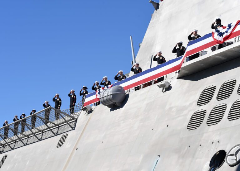 180203-N-RG360-0209 SAN DIEGO (Feb. 3, 2018) Sailors assigned to littoral combat ship USS Omaha (LCS 12) salute as they man the rails during the ship's commissioning ceremony at Broadway Pier in downtown San Diego. Omaha is the 11th littoral combat ship to enter the fleet and the sixth of the Independence variant. The ship is named for the city of Omaha, Nebraska and is assigned to Naval Surface Forces, U.S. Pacific Fleet. (U.S. Navy photo by Mass Communication Specialist 1st Class​ Melissa K. Russell/Released)