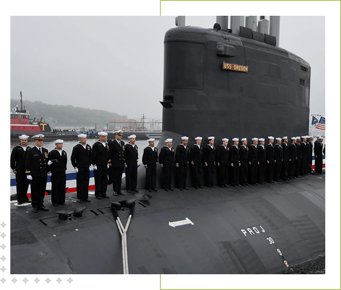 A group of sailors standing on the deck of an ocean going ship.