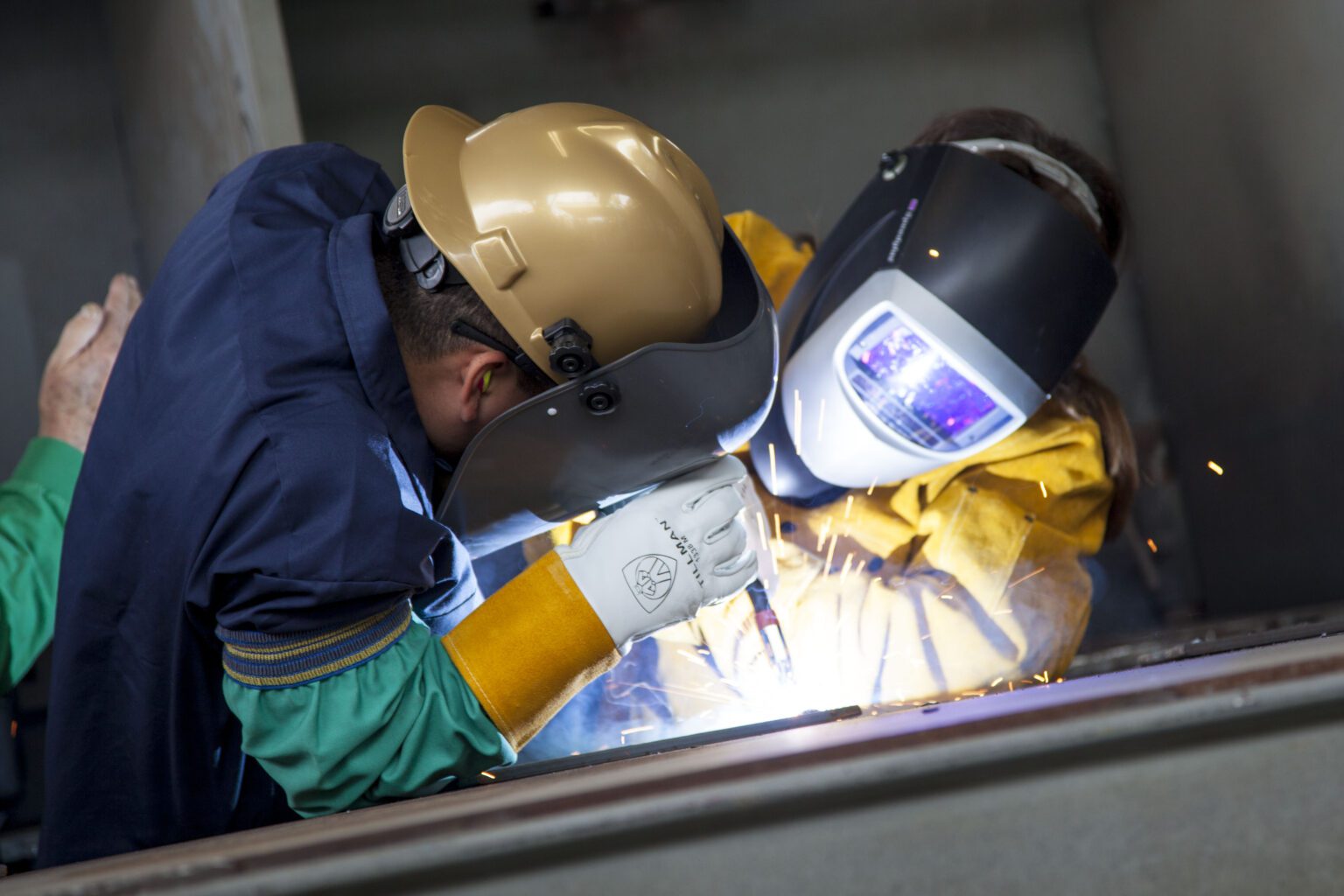 Welders working with sparks flying.