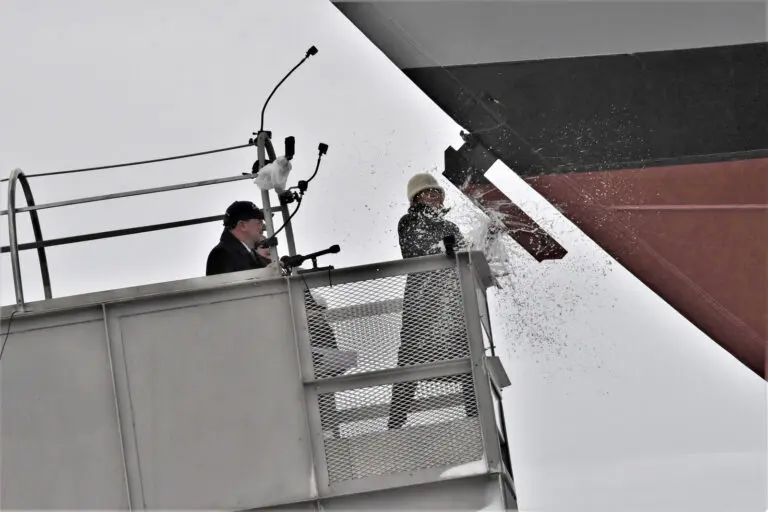 Ship sponsor Jill Donnelly breaks a bottle of champagne across the bow during the christening ceremony for the nations 17th Littoral Combat Ship, the future USS INDIANAPOLIS, at the Fincantieri Marinette Marine shipyard on April 14. (PRNewsfoto/Lockheed Martin)