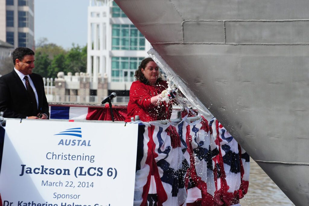 140322-O-ZZ999-202
MOBILE, Ala. (March 22, 2014) Dr. Katherine Holmes Cochran, Ph.D., ship's sponsor for the littoral combat ship Pre-Commissioning Unit (PCU) Jackson (LCS 6), breaks a bottle across Jackson's bow during a christening ceremony at Austal USA shipyard in Mobile, Ala. (U.S, Navy photo courtesy of Austal U.S.A./Released)