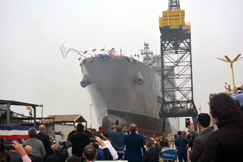 Military Sealift Command's newest ship, fleet replenishment oiler USNS Harvey Milk (T-AO 206), slides into the water during the christening ceremony at General Dynamic NASSCO, San Diego.  The ship honors Navy veteran and LGBT activist Harvey Milk, one of the first openly gay candidates elected to public office as a member of the San Francisco Board of Supervisors in 1978.