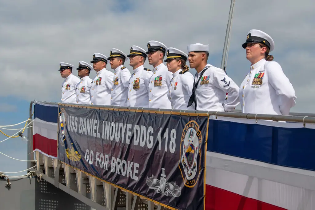 PEARL HARBOR, Hawaii (Dec. 8, 2021) The crew of the Navy's newest guided-missile destroyer, USS Daniel Inouye (DDG 118), man the rails during the commissioning ceremony of USS Daniel Inouye. Homeported at Joint Base Pearl Harbor-Hickam, DDG 118 is the first U.S. Navy warship to honor the Honorable Daniel K. Inouye, a U.S. senator from Hawaii who served from 1962 until his death in 2012. During World War II, Inouye served in the U.S. Army’s 442nd Regimental Combat Team, one of the most decorated military units in U.S. history. For his combat heroism, which cost him his right arm, Inouye was awarded the Medal of Honor. (U.S. Navy photo by Mass Communication Specialist 2nd Class Nick Bauer)