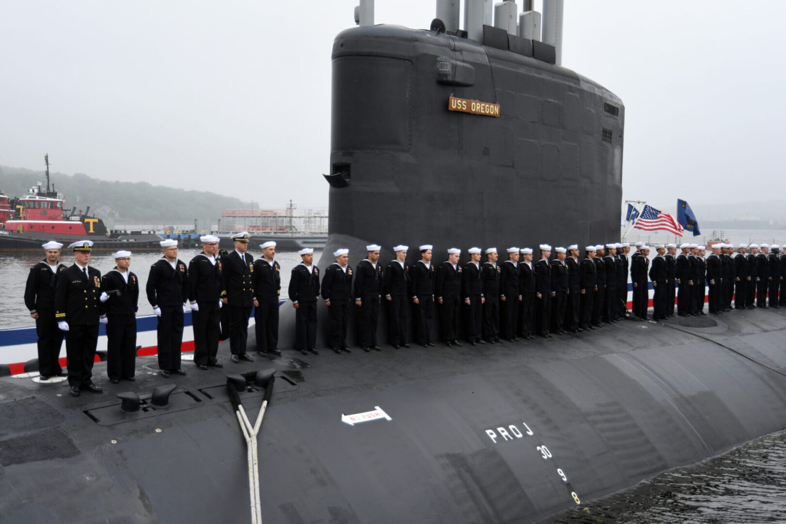 220528-N-GR655-0202 GROTON, Connecticut (May 28, 2022) – Crewmembers attached to the Virginia-class fast attack submarine USS Oregon (SSN 793) man the ship during a commissioning ceremony in Groton, Conn., May 28, 2022. SSN 793, the third U.S Navy ship launched with the name Oregon and first in more than a century, is a flexible, multi-mission platform designed to carry out the seven core competencies of the submarine force: anti-submarine warfare; anti-surface warfare; delivery of special operations forces; strike warfare; irregular warfare; intelligence, surveillance and reconnaissance; and mine warfare. (U.S. Navy photo by Chief Petty Officer Joshua Karsten)