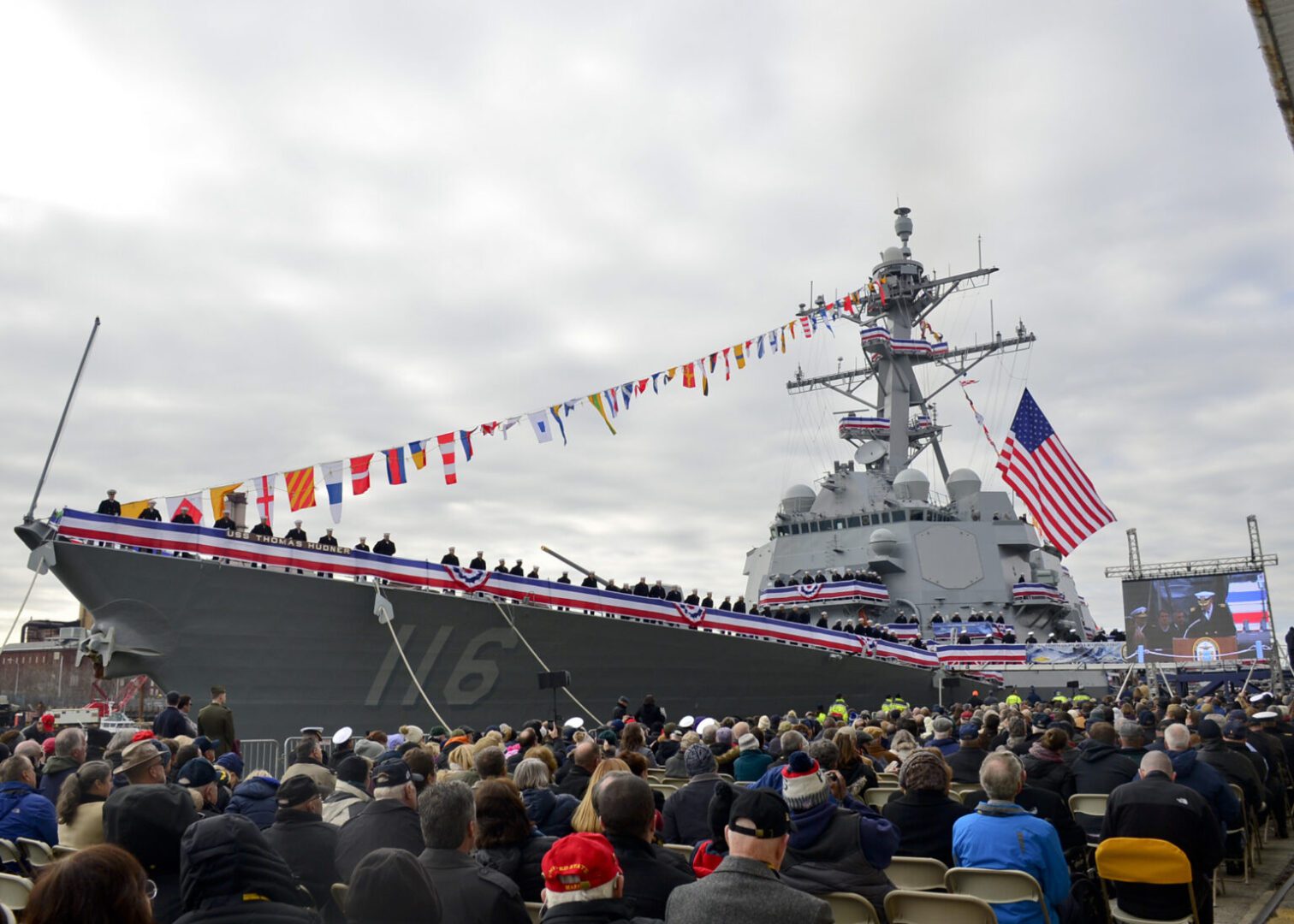 BOSTON (Dec. 1, 2018) Crewmembers of USS Thomas Hudner (DDG 116) man the rails as the ship comes to life during her commissioning ceremony. The guided-missile destroyer is the 66th Arleigh Burke-class destroyer and the first warship named for Capt. Thomas J. Hunder, Jr., who earned the Medal of Honor for the Battle of Chosin Reservoir in the Korean War. (U.S. Navy photo by Airman Olivia K. Manley)