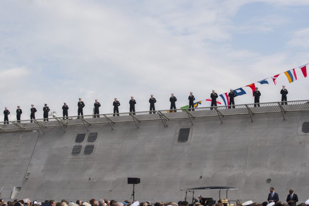 Crew members of the USS Charleston (LCS-18) officially man the ship for the first time at its commissioning ceremony March 2, 2019, in Charleston, S.C. The USS Charleston—a Littoral Combat Ship intended for more shallow waters than typical Navy vessels—is the sixth naval ship named after the city. Although the ship will be stationed in San Diego, CA, the captain and members of the crew will make annual trips to Charleston to interact with the city and work with the Navy League of Charleston to maintain the relationship between the namesake city and the ship.