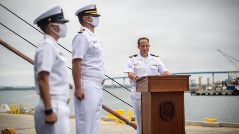 SAN DIEGO (June 20, 2020) – Cmdr. R.J. Zamberlan, the commanding officer of the Navy's newest littoral combat ship, USS Kansas City (LCS 22), reads his orders during the ship’s commissioning ceremony. The Navy commissioned LCS 22, the second ship in naval history to be named Kansas City, via naval message due to public health safety and restrictions of large public events related to the novel coronavirus (COVID-19) pandemic. Kansas City is homeported at Naval Base San Diego. (U.S. Navy photo by Mass Communication Specialist 2nd Class Alex Corona)